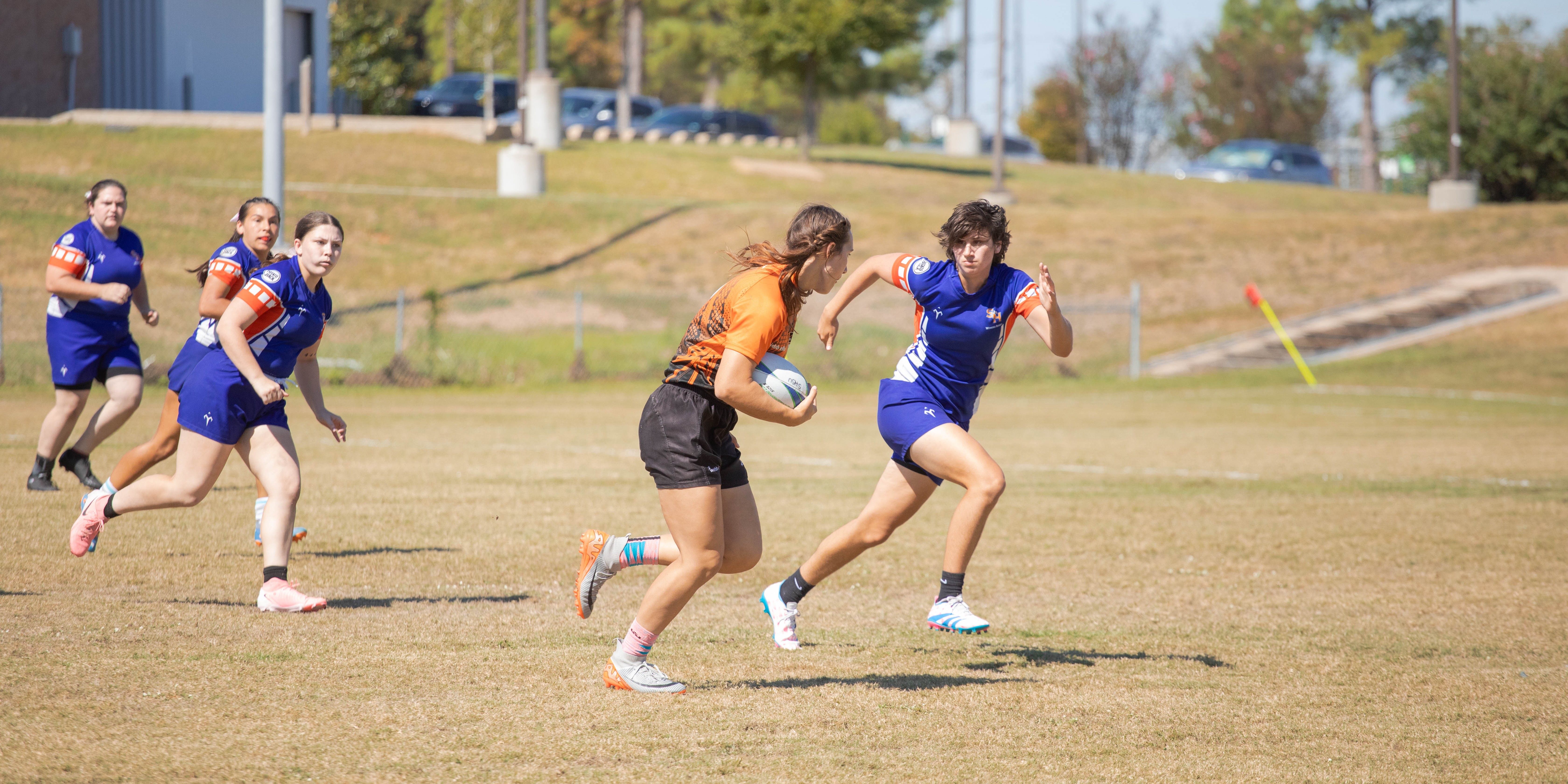 wrugby playing defense against opposing team on a sunny day